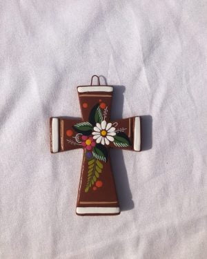 Mini clay cross with painting of flowers on it