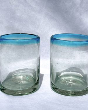 two glass tumblers with aqua rims